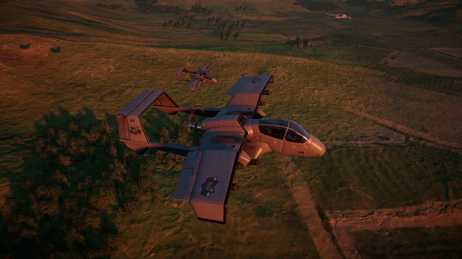 Two CI-22 Crickets flying alongside each other low to the ground at sunset